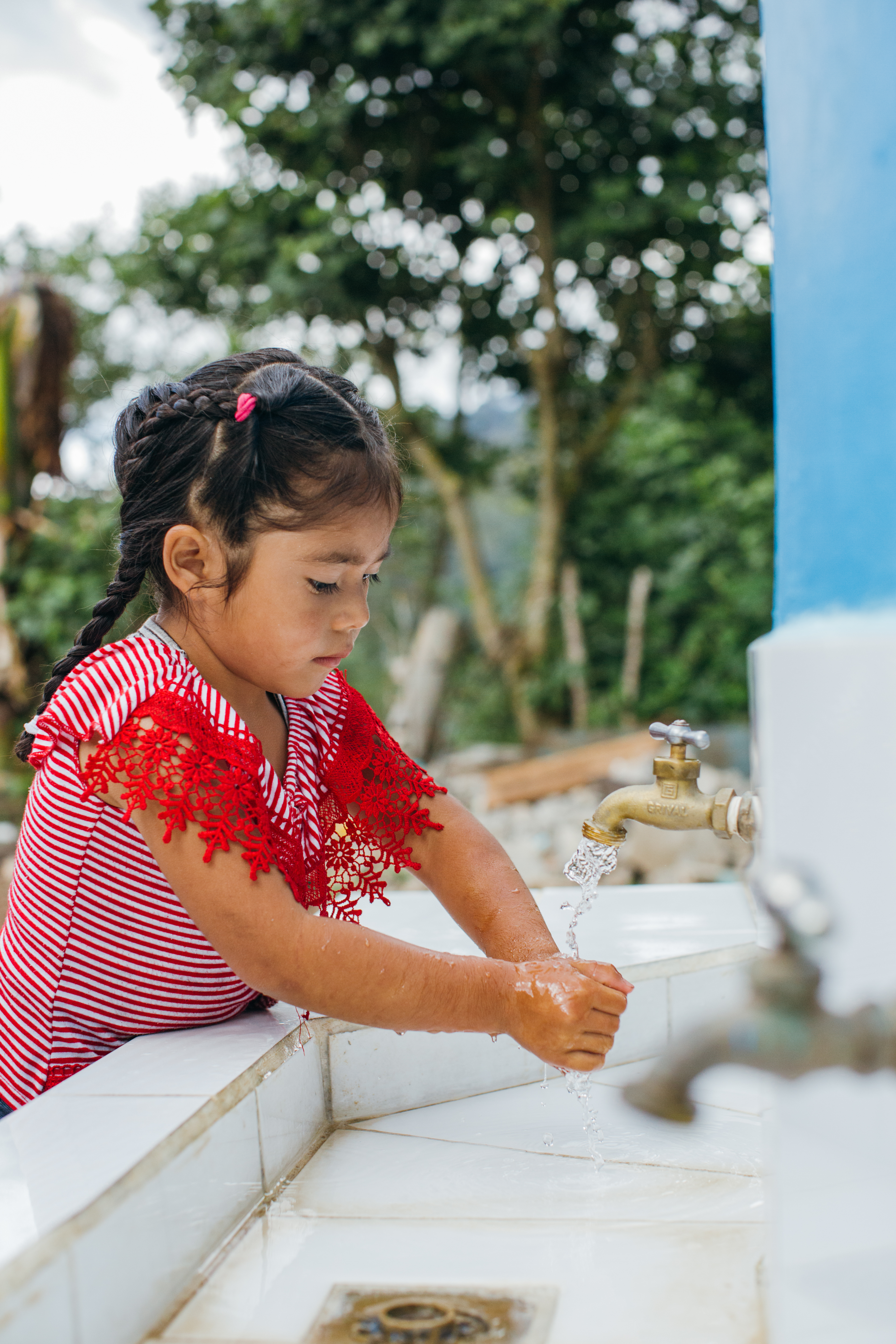 little girl washing her hands | Clean Water and Sanitation Services | About Water For People