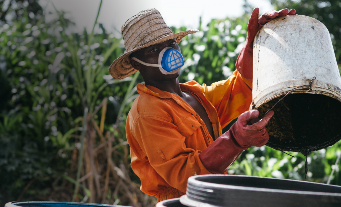 Man emptying waste into a bucket