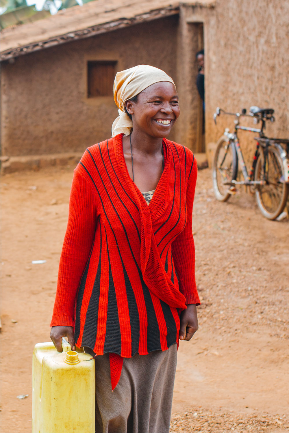 smiling woman carrying water | Best Water Organizations | Everyone Forever | Water For People