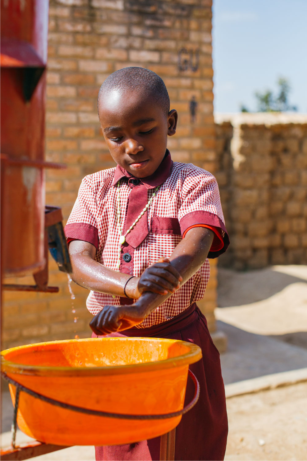 child washing his hands | Clean Water in Rwanda | Where We Work | Water For People