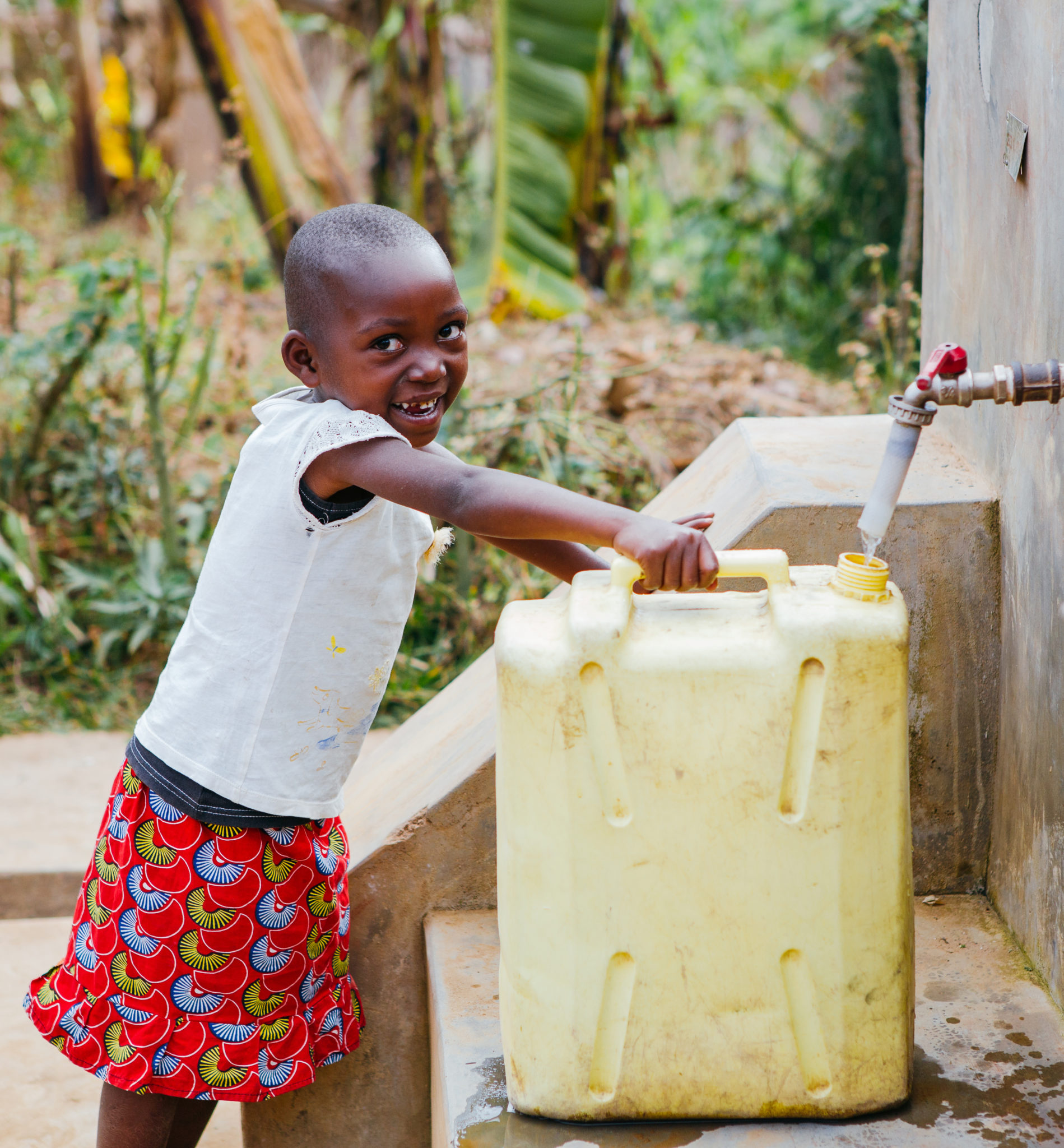 little girl filling up water jug | Fundraise for Water | Get Involved | Water For People