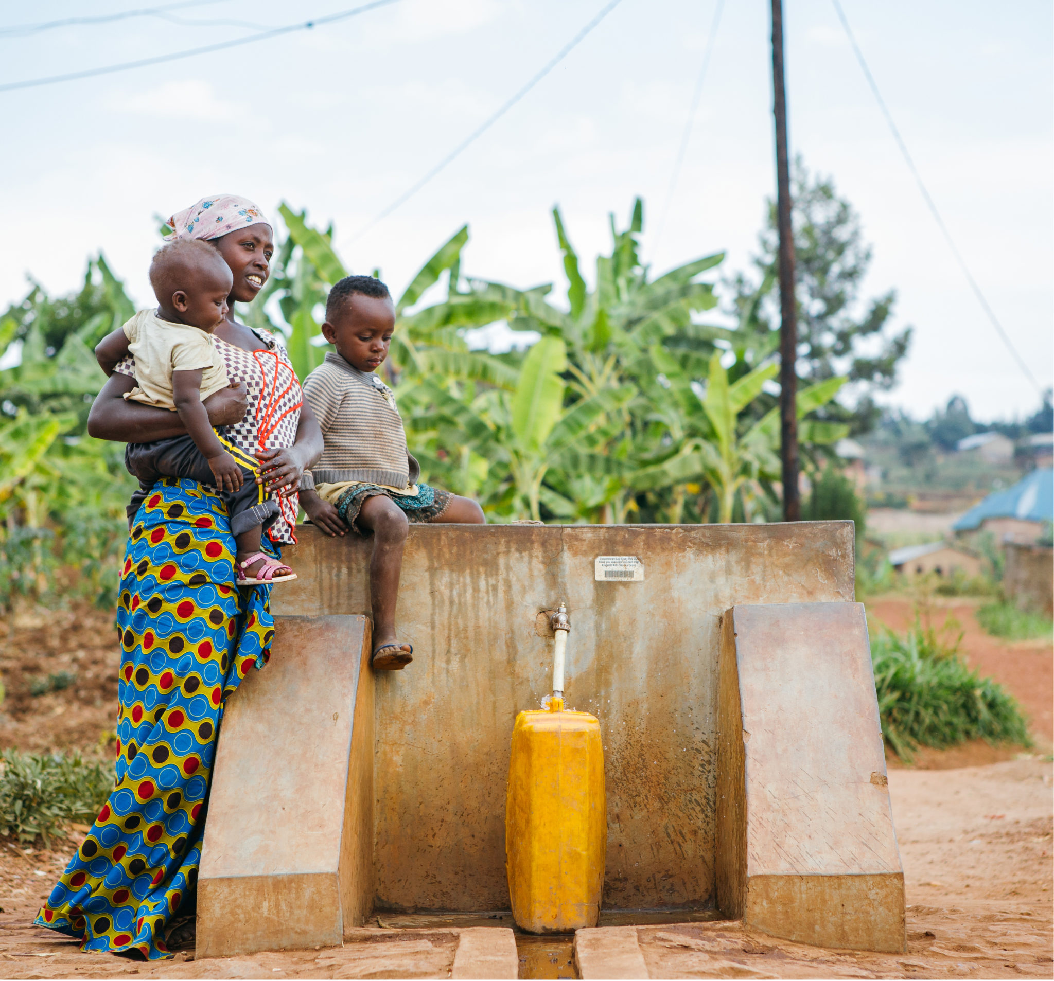 Rwanda07_Rulindo_Shyorongi_20180725-29 mother and children filling up water jug | Fundraise for Water | Get Involved | Water For People