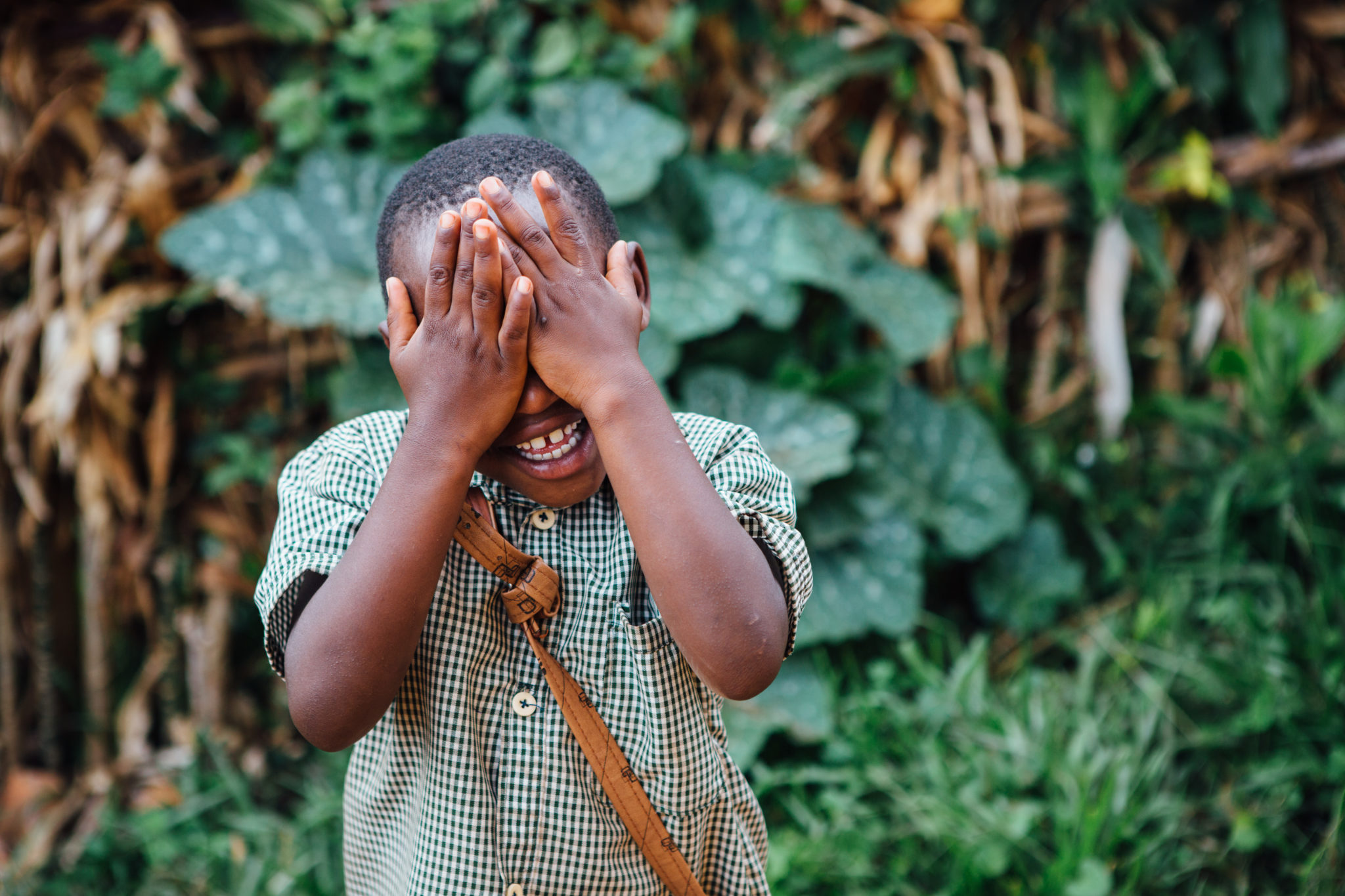 boy hiding his face | Water and Sanitation Engineers | World Water Corps | Water For People