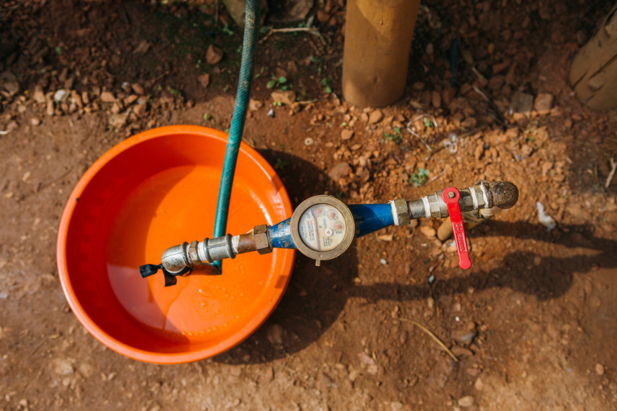 Water tap and meter with orange bucket