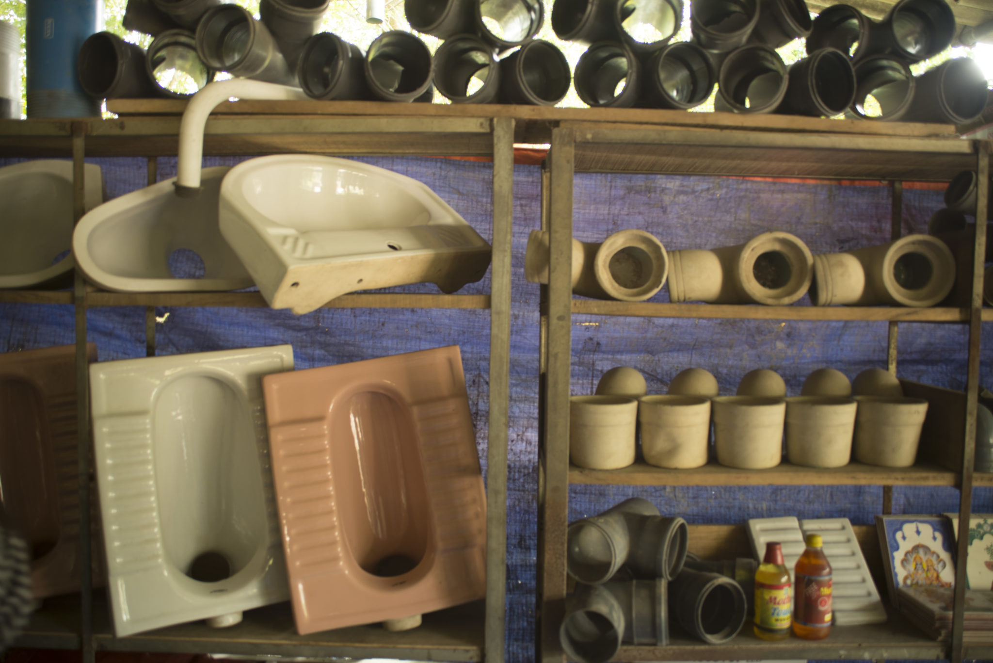 photograph of pipes, toilets, and a sink in a local shop