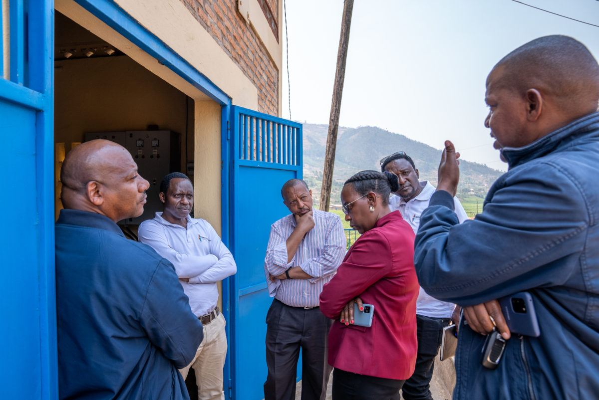 Samson, alongside the Mayor and Vice Mayor of Rulindo District and colleagues from our Rwanda office, listen to the site supervisor of a vermafiltration plant in Rwanda.