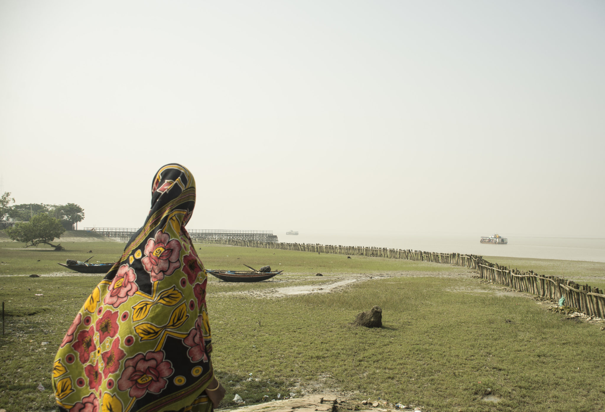 Xylem-India-Consent-India-South24Parganas-Sagar (8) photograph of a woman looking into the distance with water and a field in the background