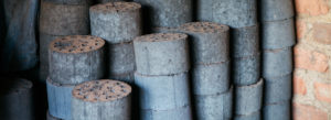 Photo showing a stack of briquettes made from fecal sludge.