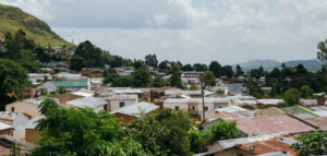 Photograph of city-view of Blantyre, with mountains in the distance and roofs in the foreground.