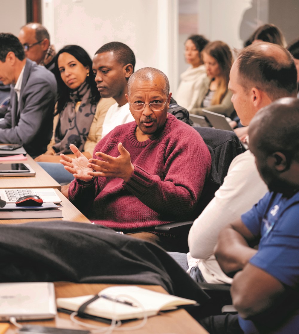 Co-CEO Samson Hailu Bekele speaks with other Water For People leaders during a team session. 