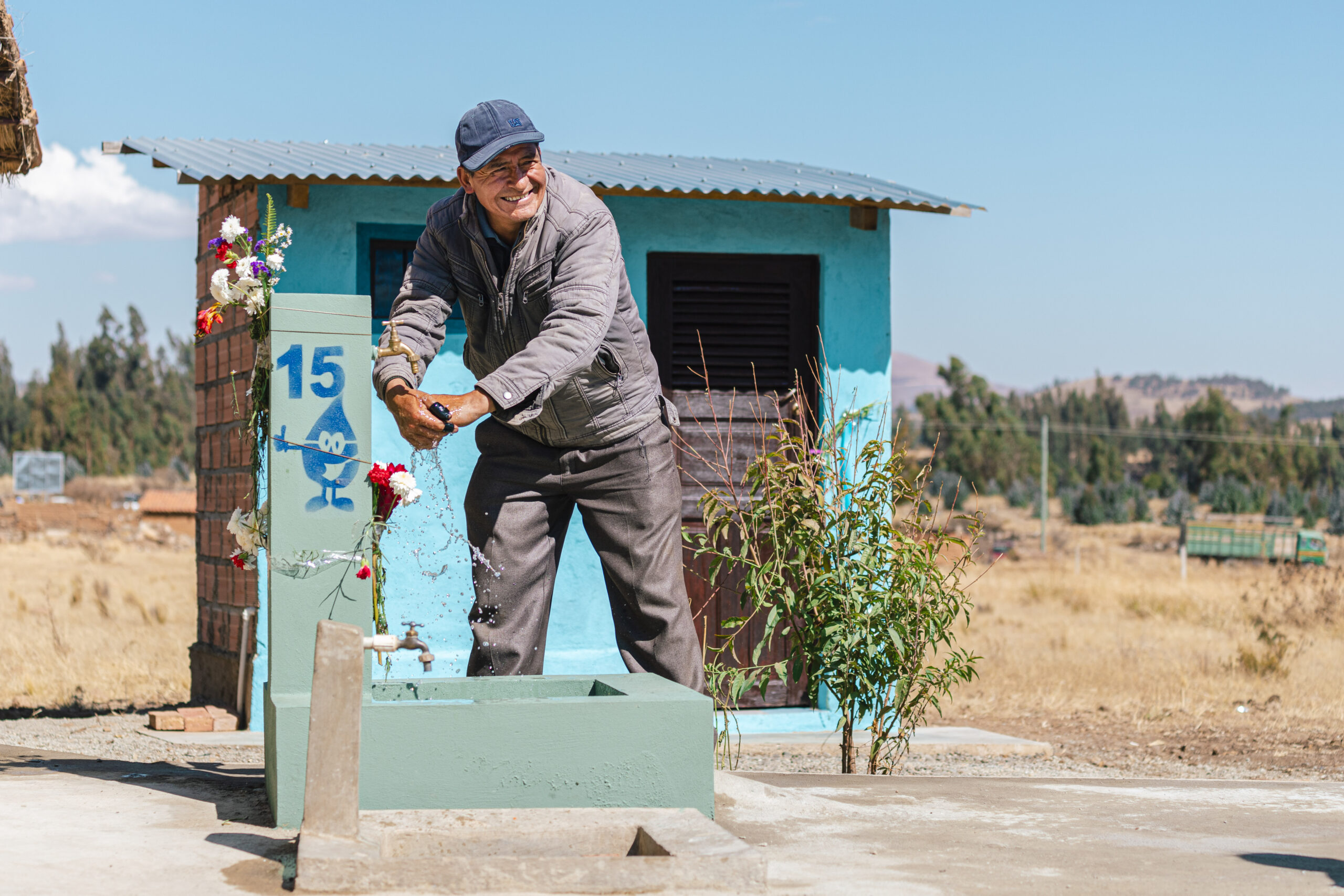 Rufino washes his hands outside his home in Villa Progreso, Bolivia. 
