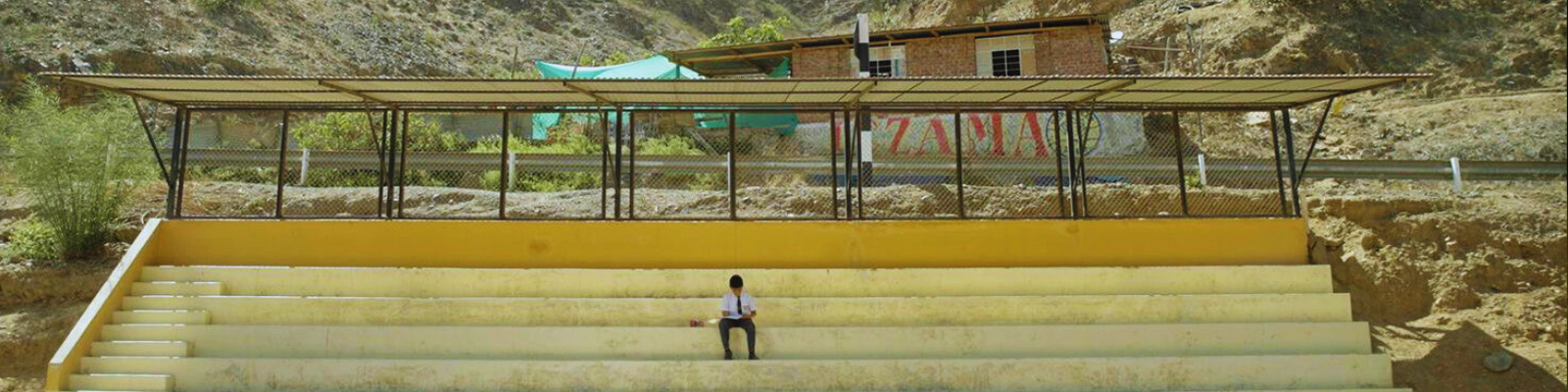 One student sitting by himself doing his homework