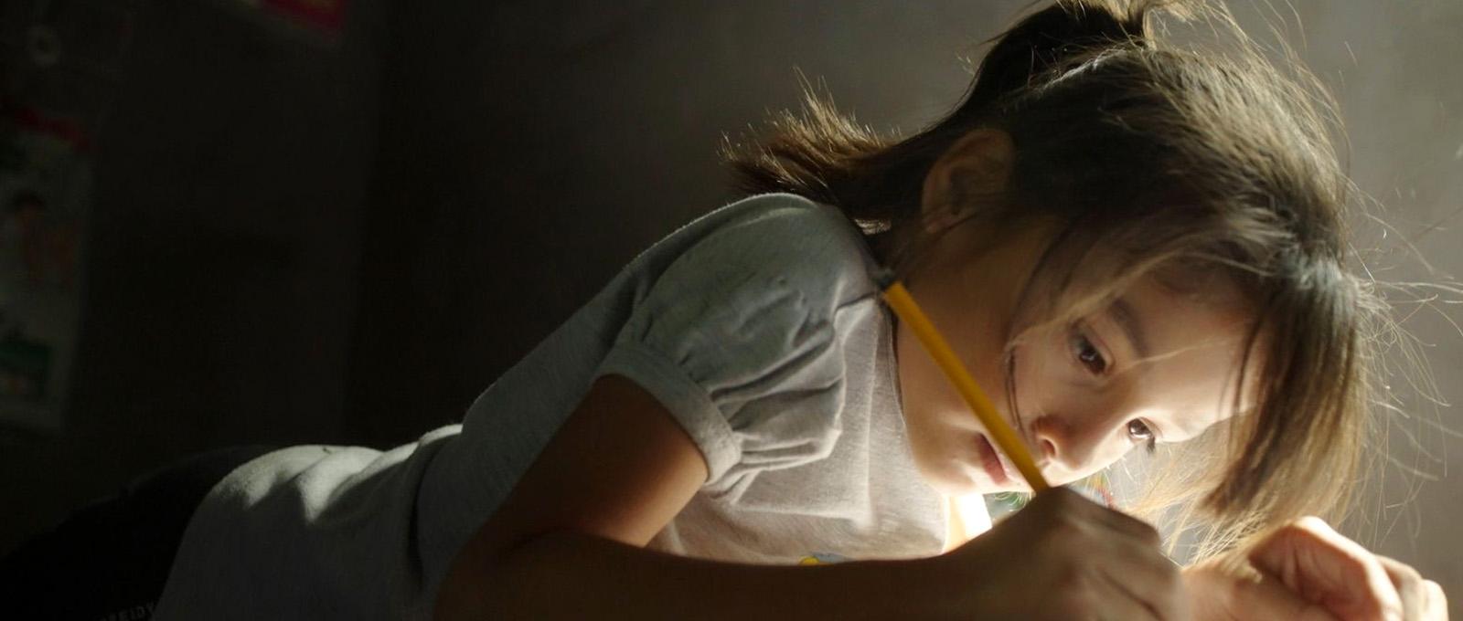 One girl holding a pencil