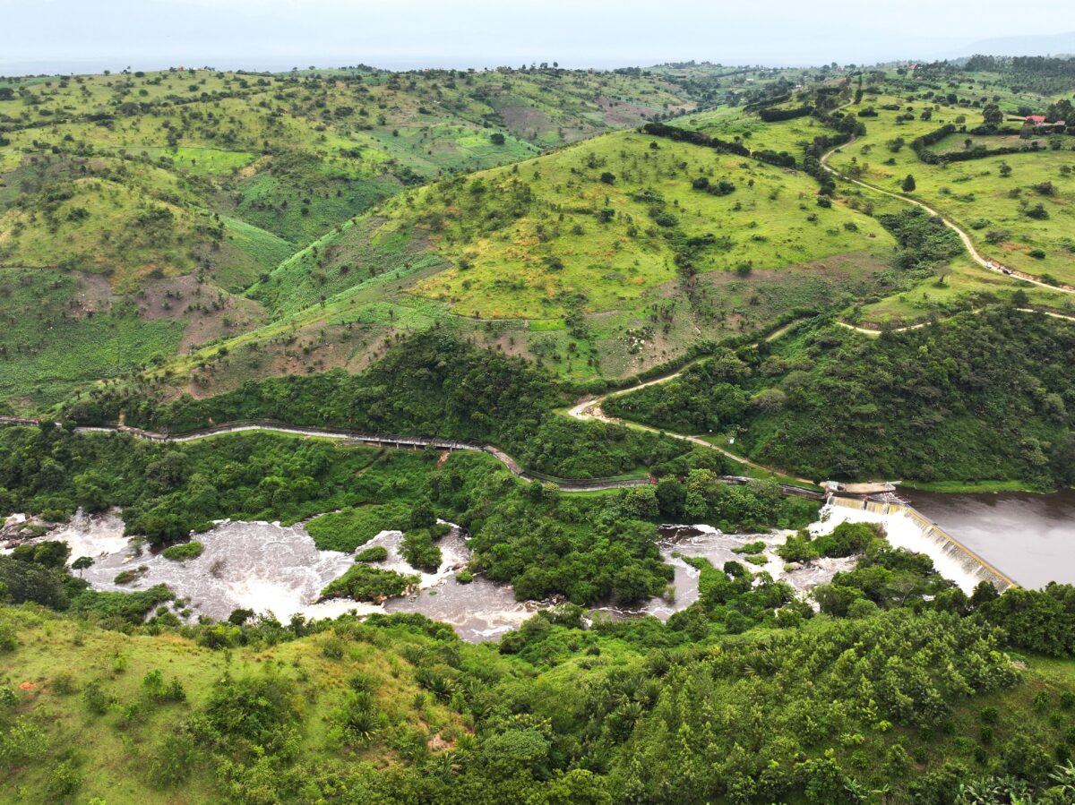Rolling green hills with the winding Mpanga river and scattered vegetation