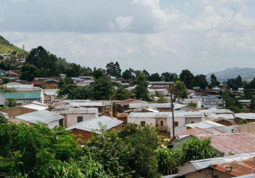 Photograph of city-view of Blantyre, with mountains in the distance and roofs in the foreground.