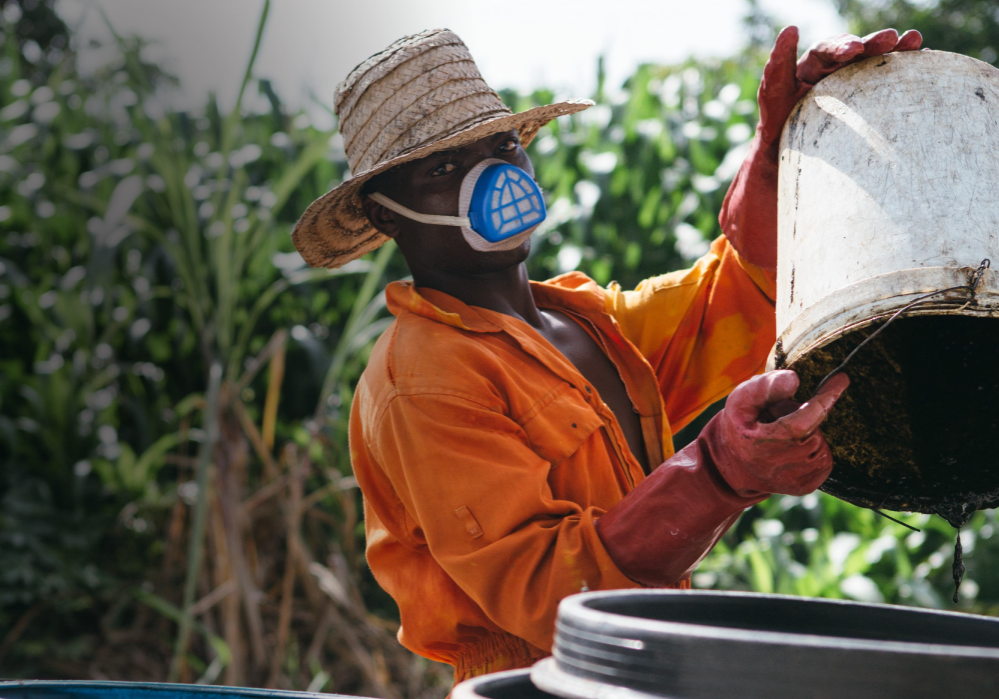 Man emptying waste into a bucket