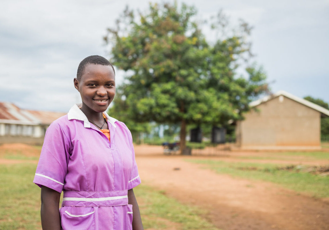 Prossy standing in front of her school in Luuka, Uganda
In Luuka District, water, sanitation and hygiene (WASH) issues are prevailing in health care
facilities. Water For People implements the Everyone Forever programme which is aimed at
demonstrating that attainment of universal WASH services is possible. The focus is on
ensuring that every school, healthcare facility and household has access to sustainable water,
sanitation and hygiene services.