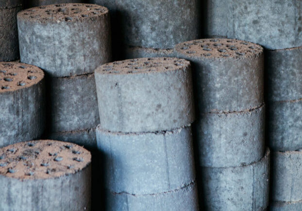 Photo showing a stack of briquettes made from fecal sludge.
